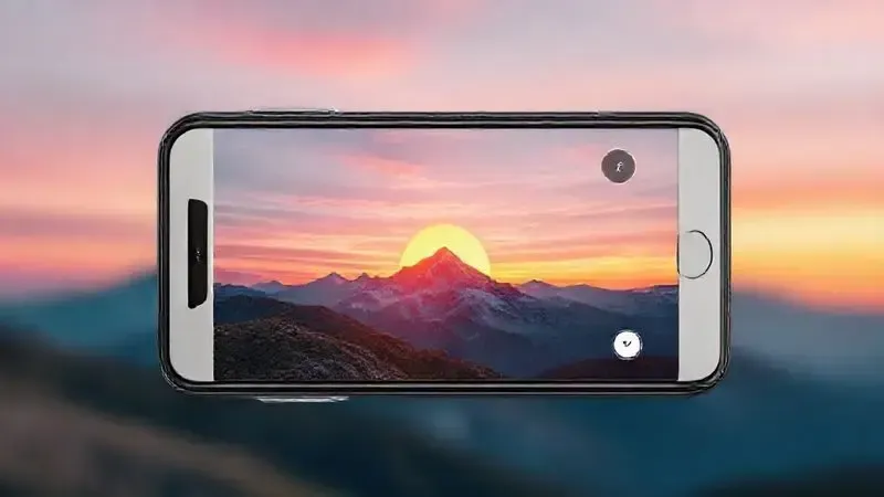 Ilustração conceitual da câmera de um smartphone capturando uma foto de paisagem em alta qualidade, representando a capacidade fotográfica do iPhone 14.